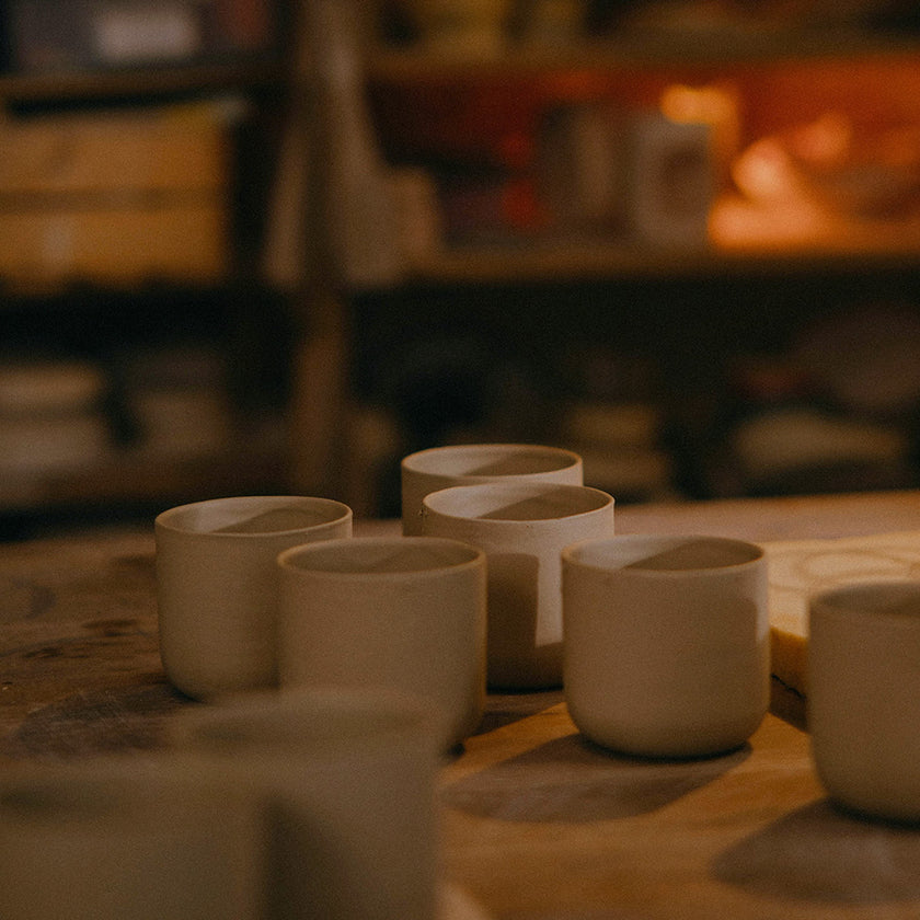 Artisan hand-pouring a Halo candle into its ceramic vessel